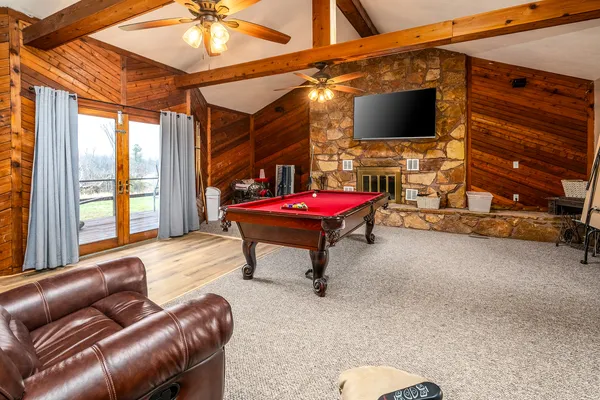 a living room with furniture a flat screen tv and outdoor view