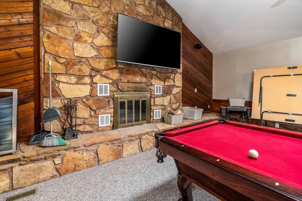 a spacious bedroom with a bed and a chandelier
