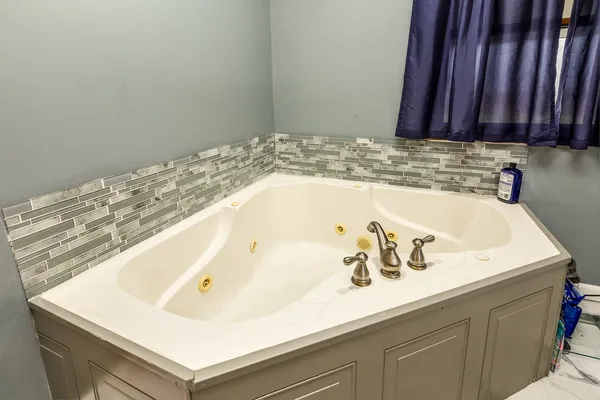 a bedroom with bed and window