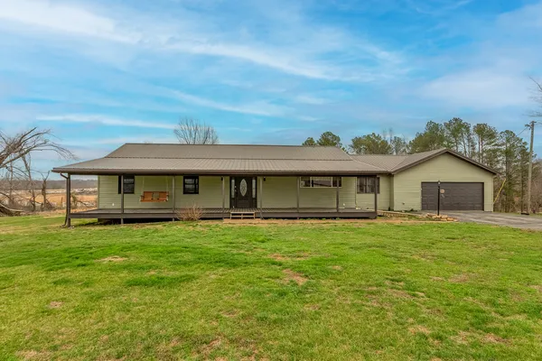 a front view of house with yard and trees