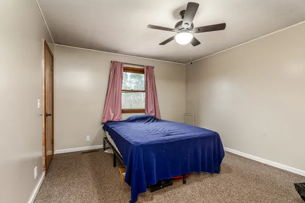 a bedroom with bed and a window