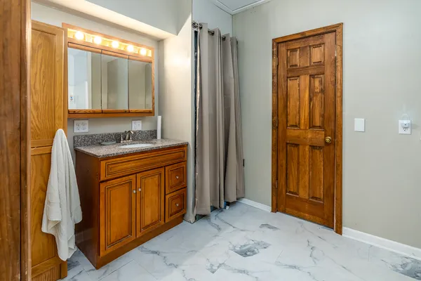 a bathroom with a granite countertop shower and a toilet