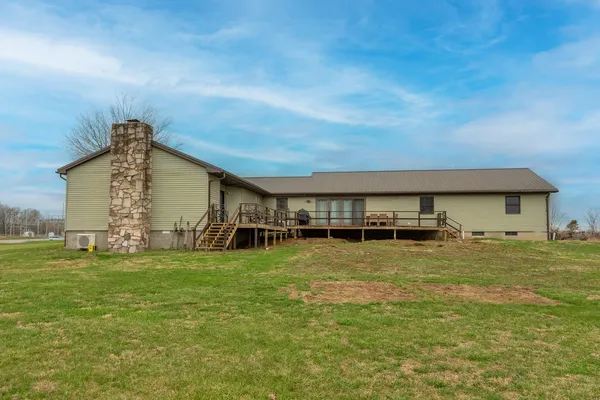 a front view of house with a garden