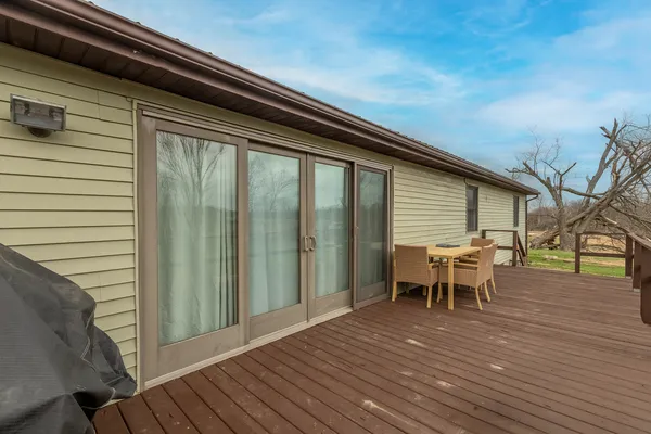 a view of a chairs and table on the balcony