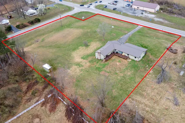 a view of a house with a backyard