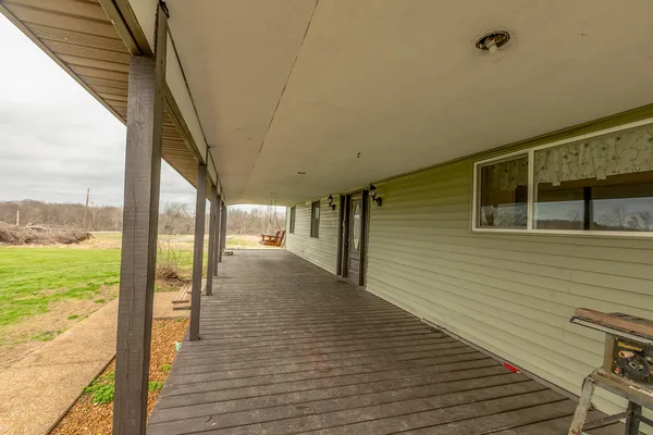 a view of a balcony with wooden floor