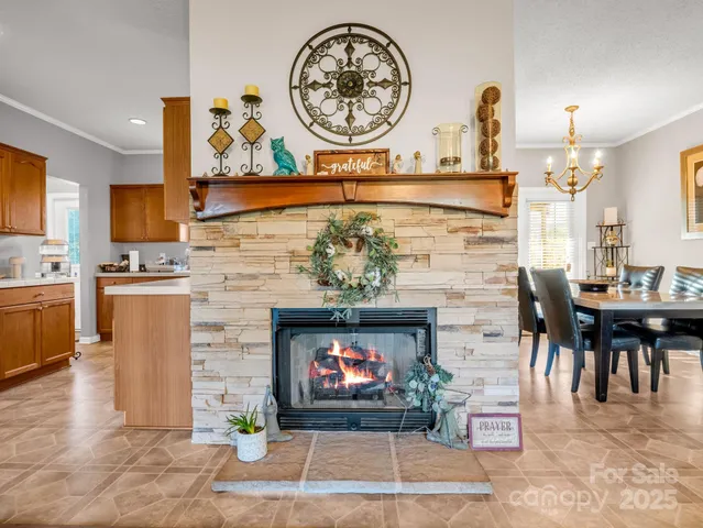 a living room with furniture a fireplace and kitchen view