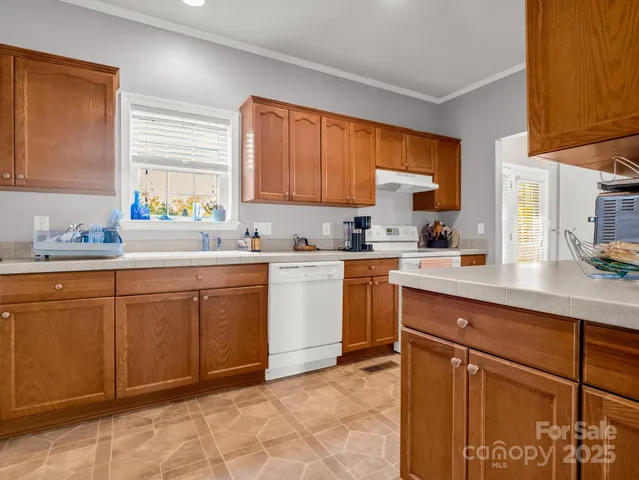 a kitchen with a sink window and cabinets