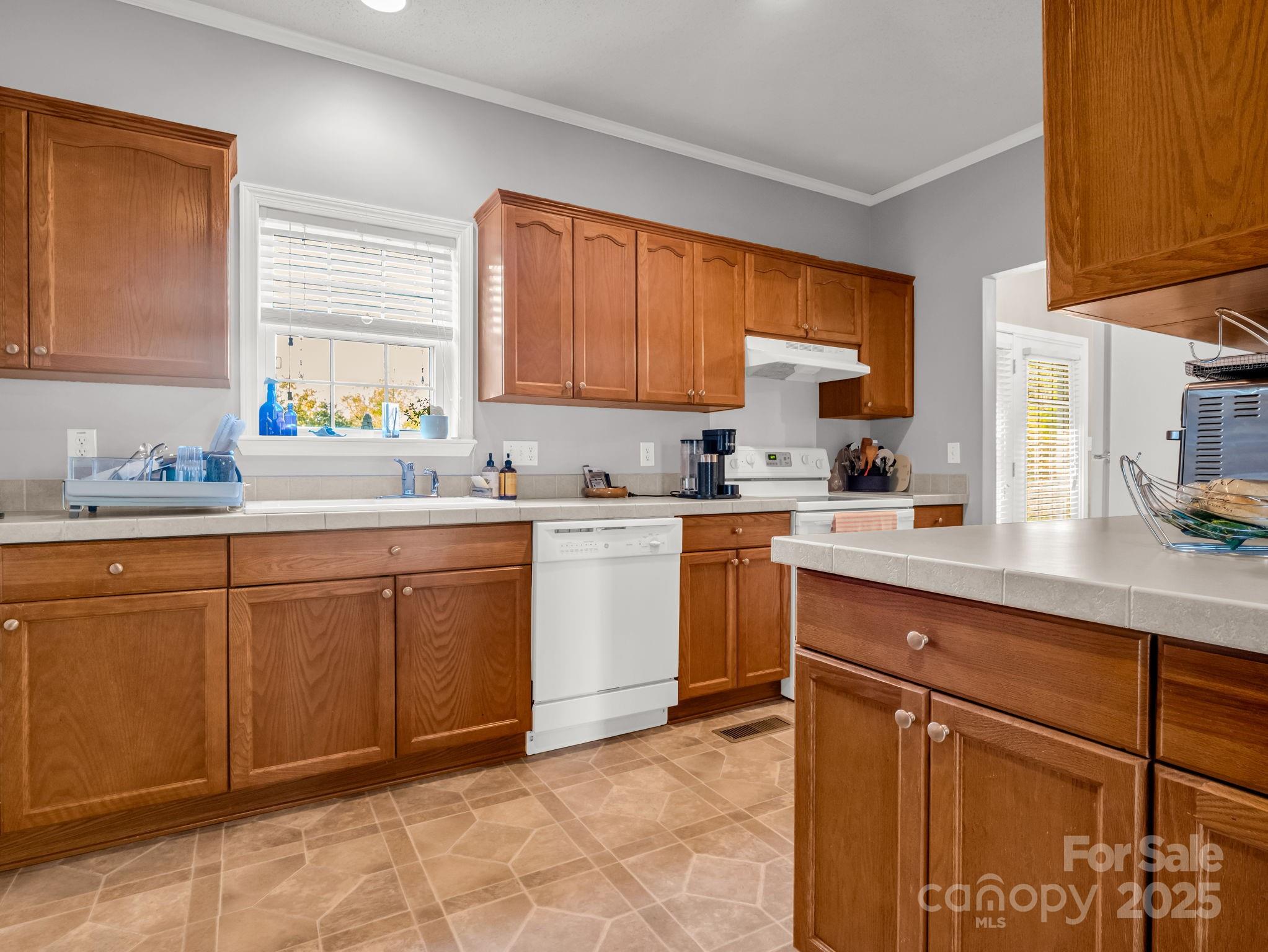 435 Brooks Road Bostic, NC 28018 - Photo 13 of 41 a kitchen with a sink window and cabinets