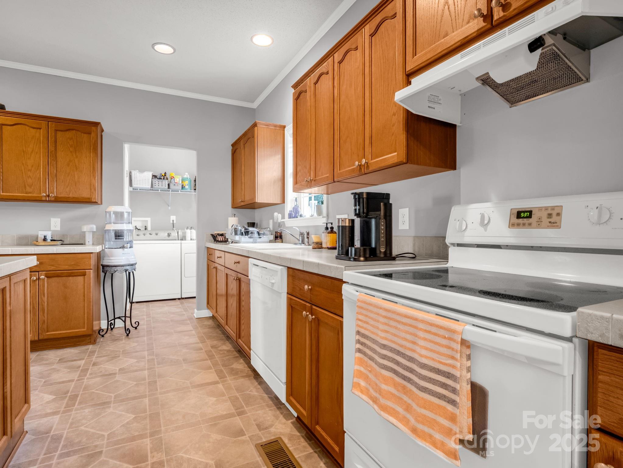 435 Brooks Road Bostic, NC 28018 - Photo 14 of 41 a kitchen with a sink a counter top space stainless steel appliances and cabinets