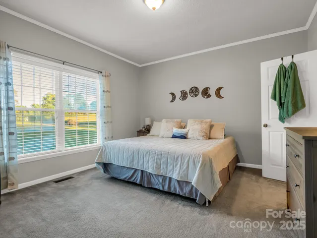 a spacious bedroom with a bed and a window