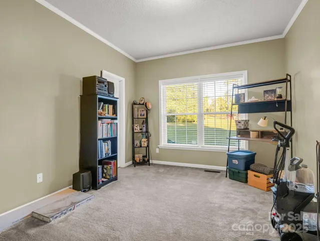 a view of a room with lounge chair and a window