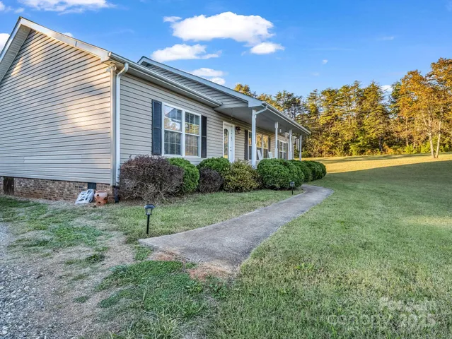 a view of backyard of house and green space