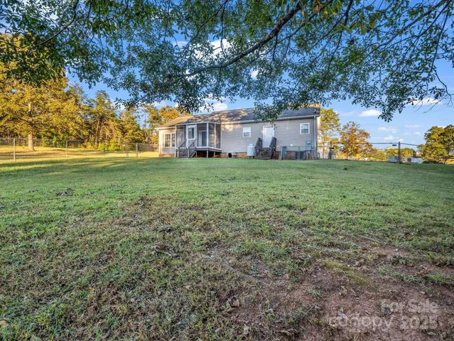 a view of a big yard with large trees
