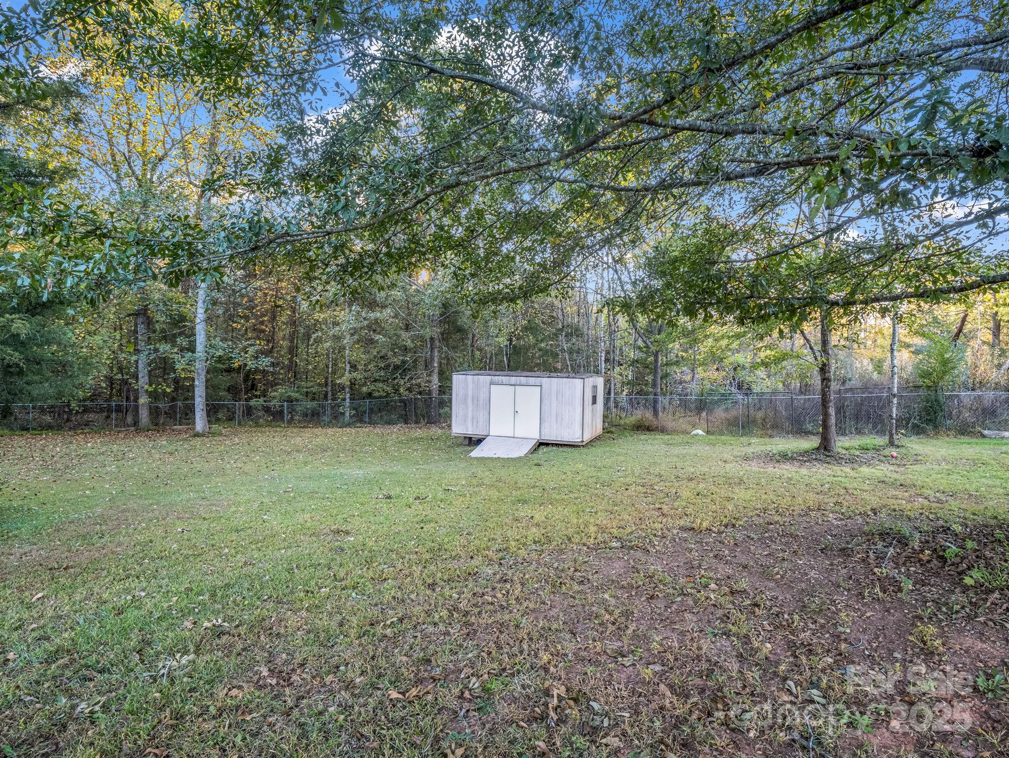 435 Brooks Road Bostic, NC 28018 - Photo 38 of 41 a backyard of a house with trees and entertaining space