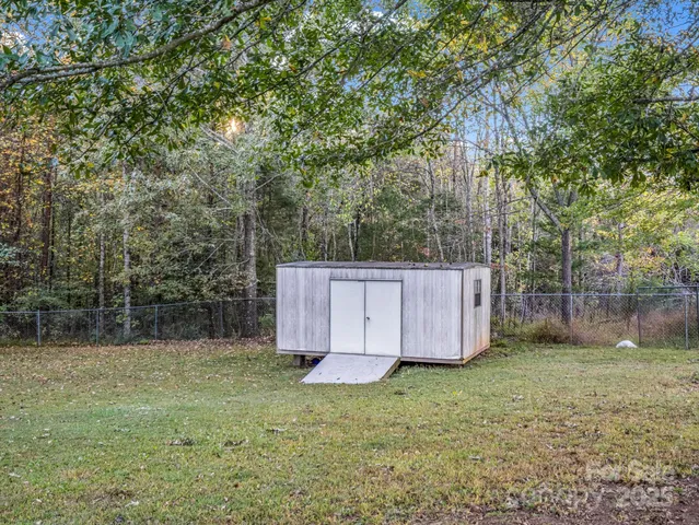 a view of backyard with small cabin