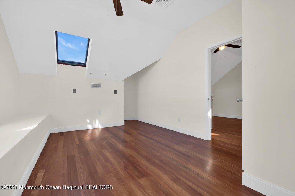 511 Passaic Avenue Spring Lake, NJ 07762 - Photo 104 of 105 an empty room with wooden floor and windows