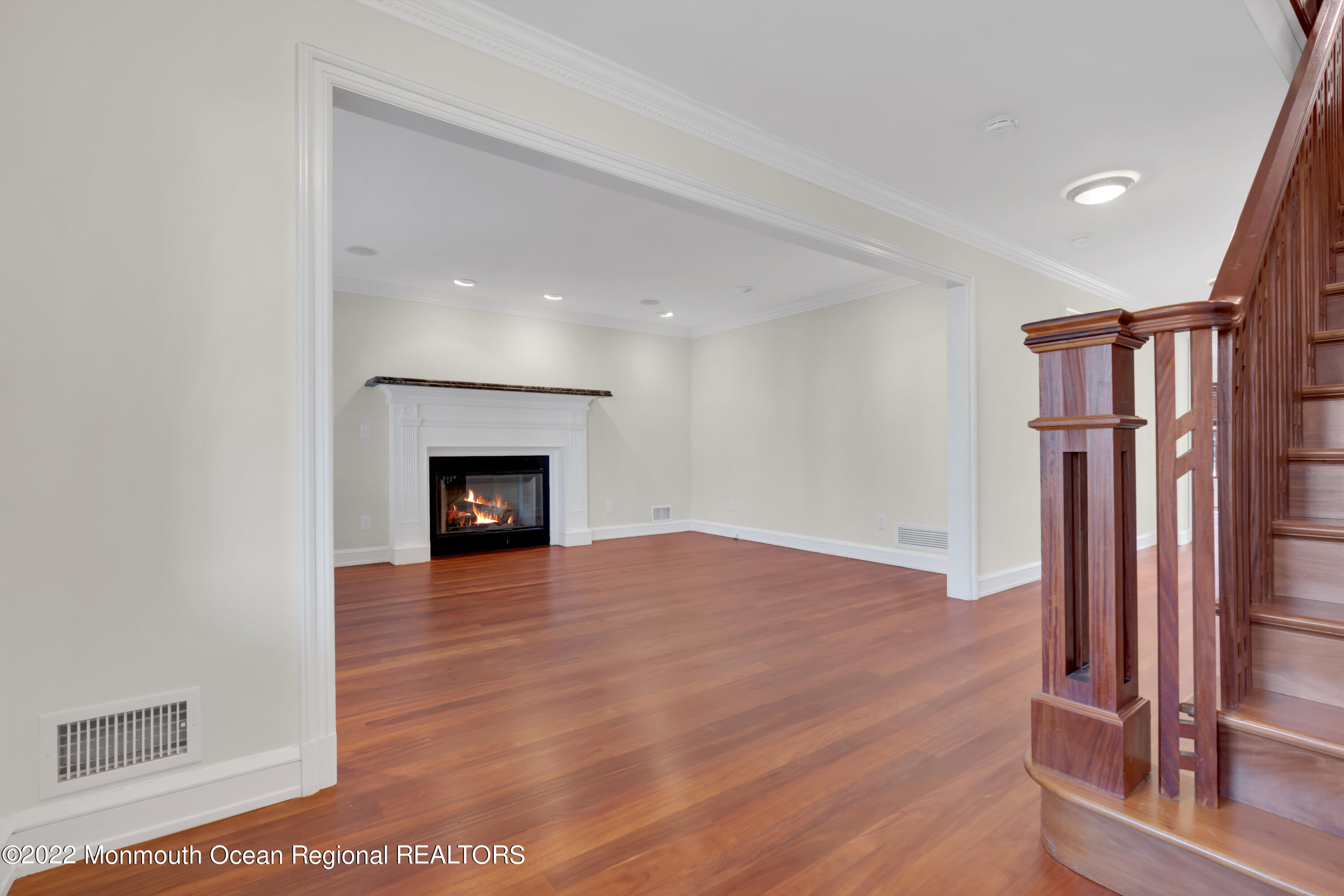 511 Passaic Avenue Spring Lake, NJ 07762 - Photo 22 of 105 a view of an empty room with wooden floor fireplace and a window