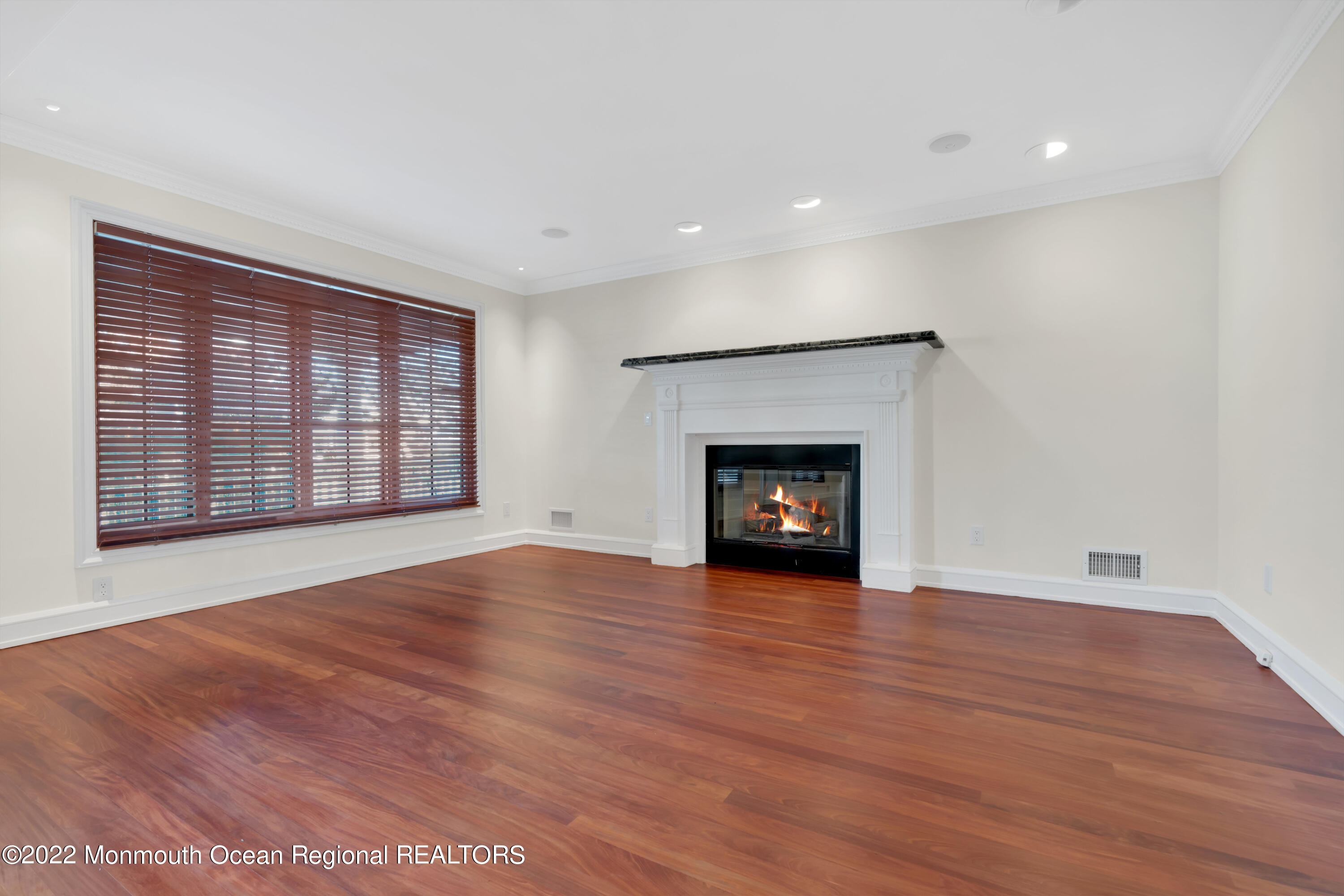 511 Passaic Avenue Spring Lake, NJ 07762 - Photo 23 of 105 an empty room with wooden floor fireplace and windows