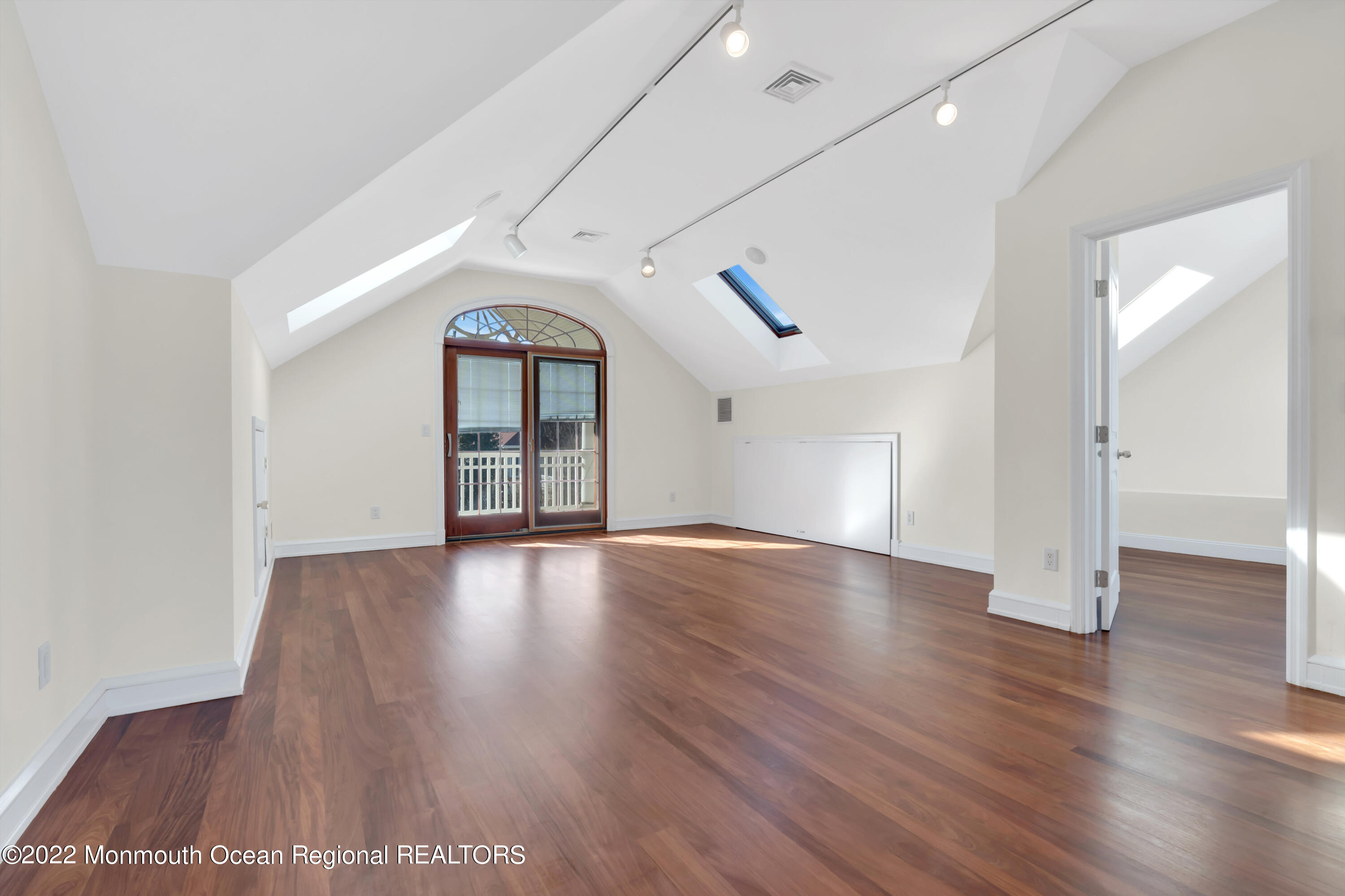 511 Passaic Avenue Spring Lake, NJ 07762 - Photo 47 of 105 an empty room with wooden floor and windows