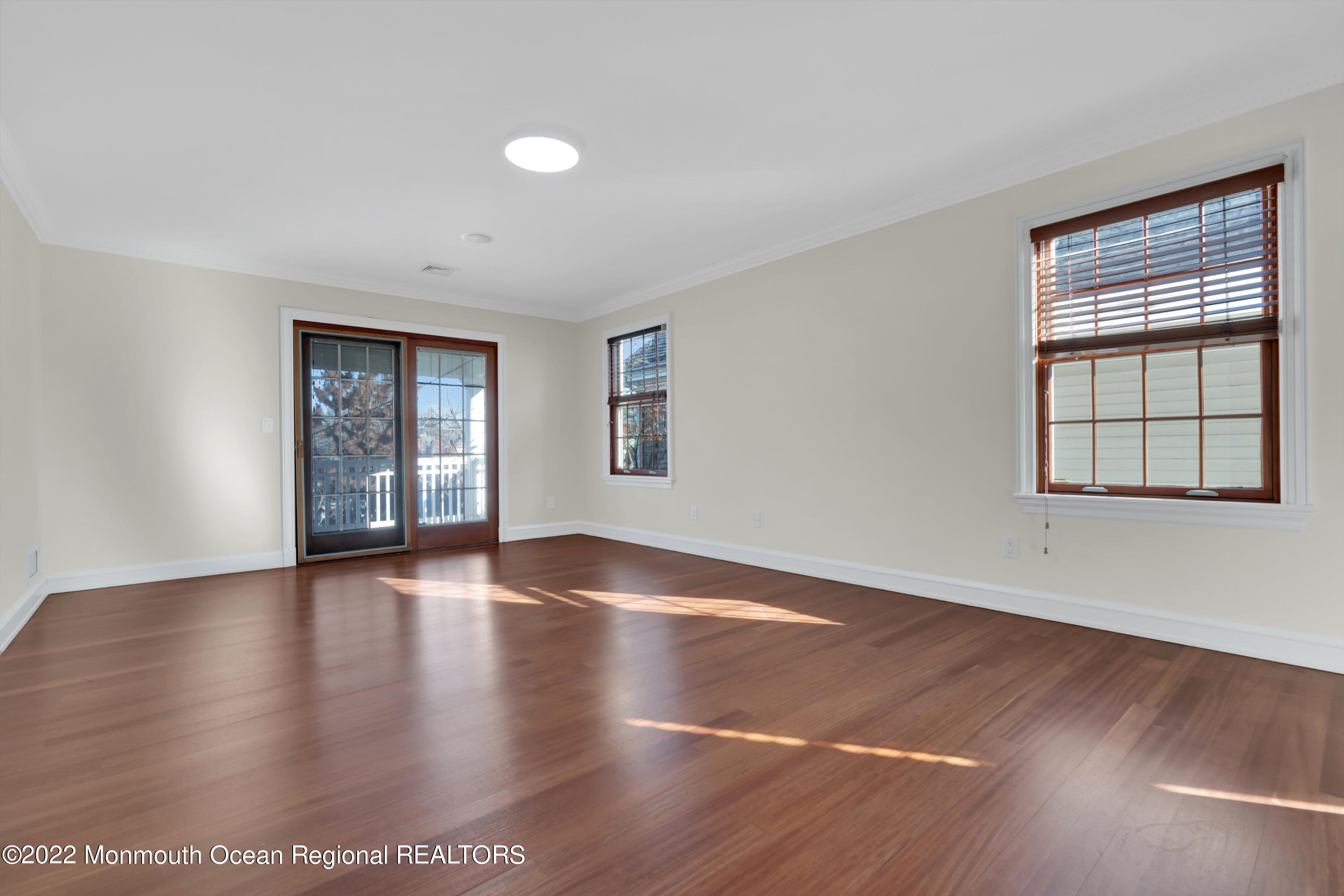 511 Passaic Avenue Spring Lake, NJ 07762 - Photo 51 of 105 an empty room with wooden floor and windows