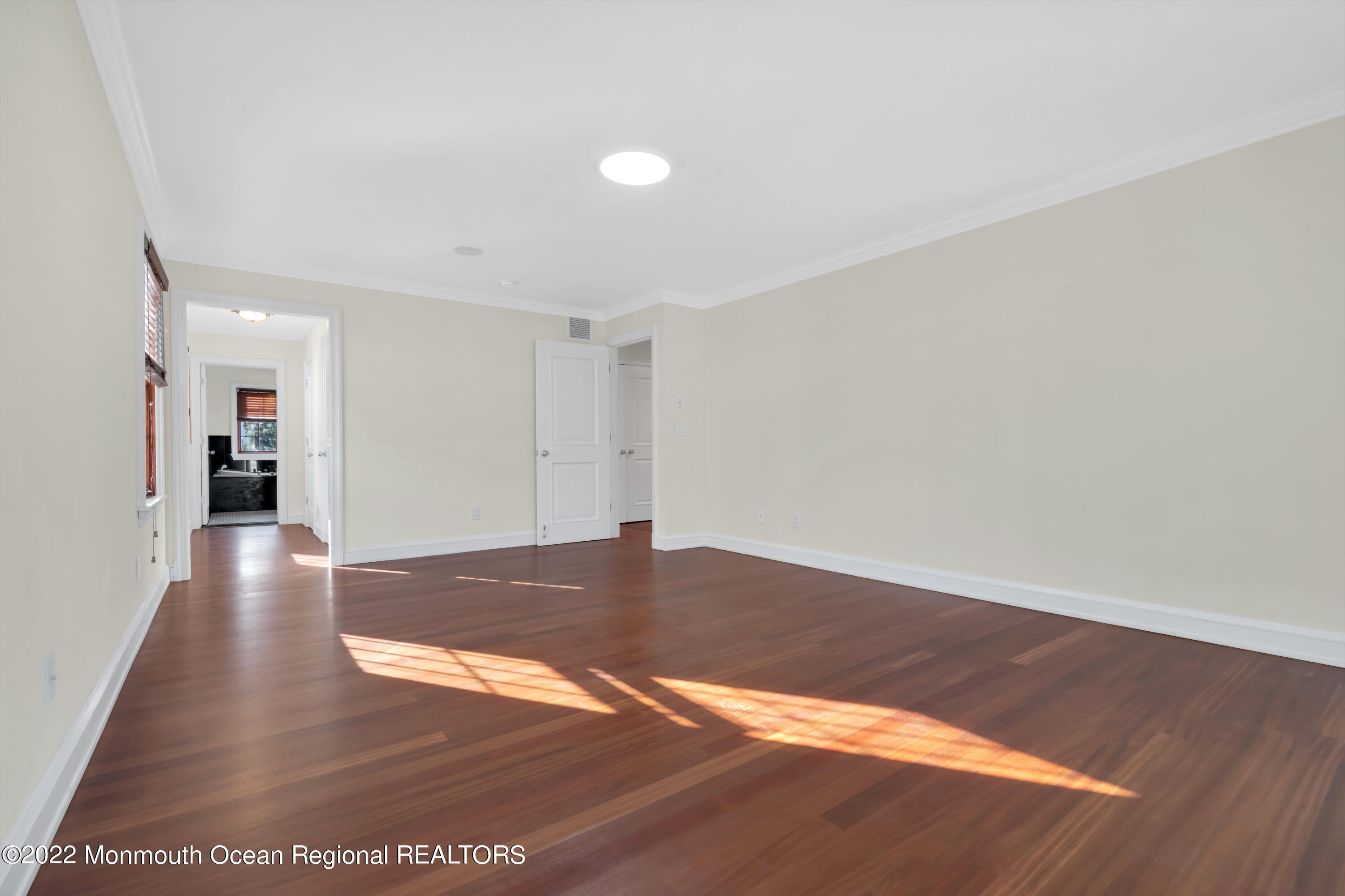 511 Passaic Avenue Spring Lake, NJ 07762 - Photo 52 of 105 a view of an empty room with wooden floor and a window
