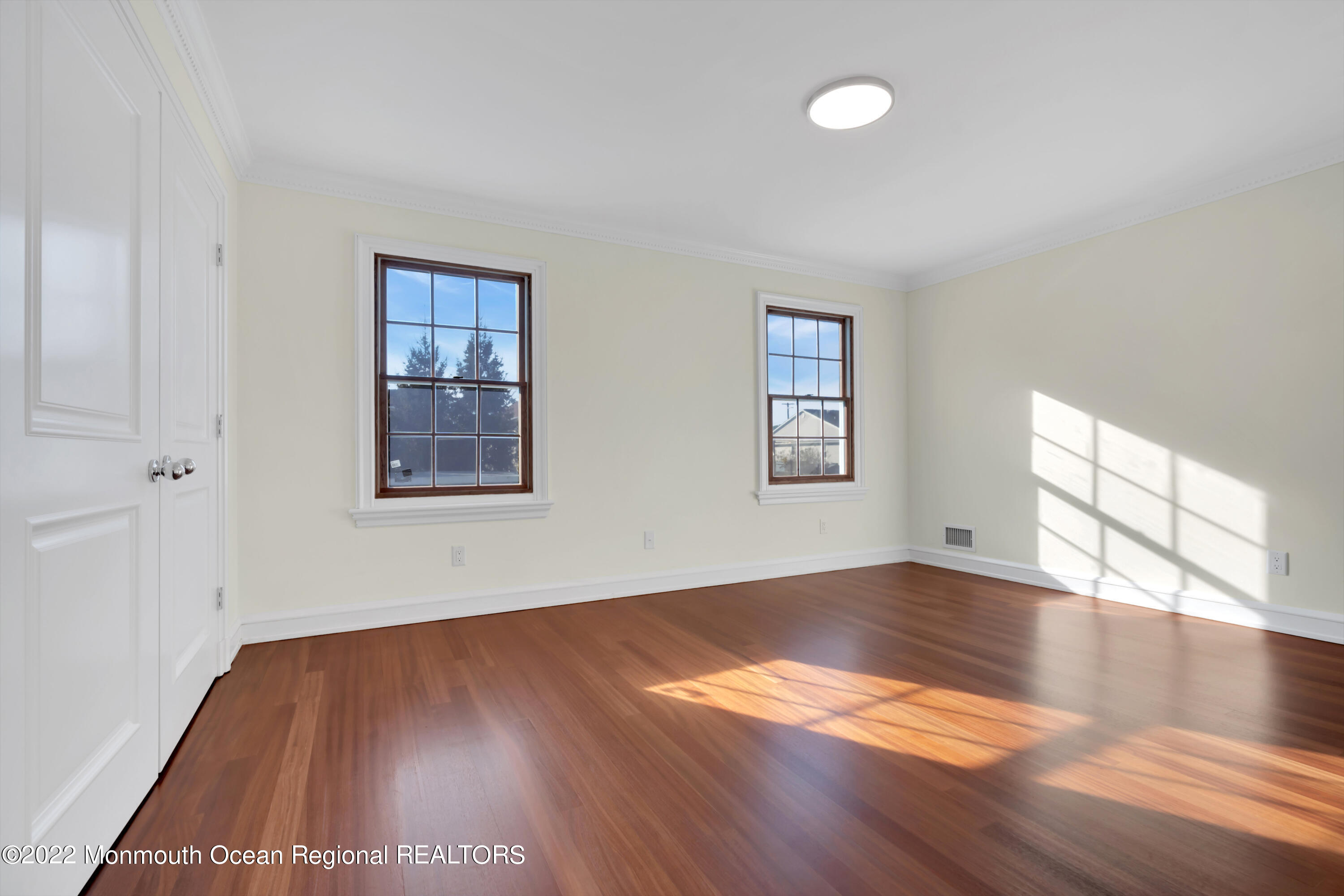 511 Passaic Avenue Spring Lake, NJ 07762 - Photo 59 of 105 an empty room with wooden floor and windows