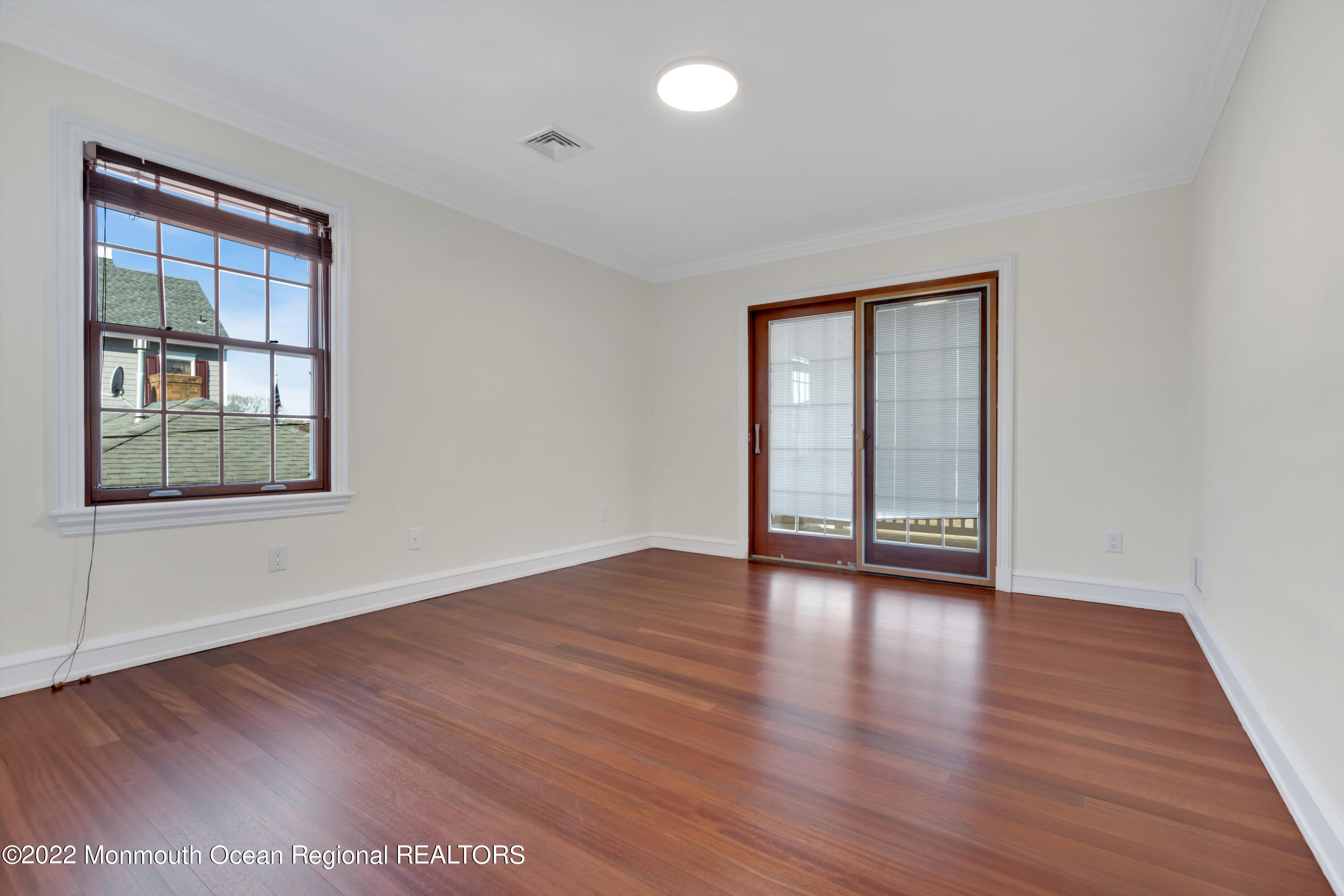511 Passaic Avenue Spring Lake, NJ 07762 - Photo 63 of 105 a view of an empty room with wooden floor and windows