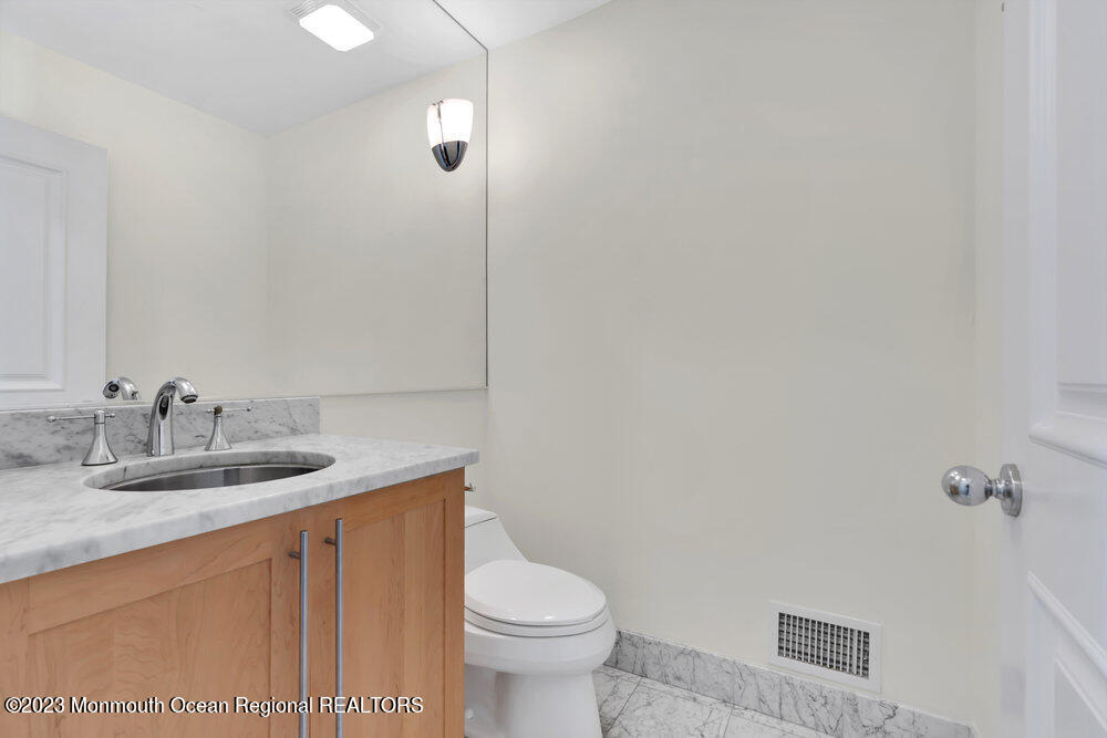 511 Passaic Avenue Spring Lake, NJ 07762 - Photo 89 of 105 a bathroom with a granite countertop sink a toilet and a mirror