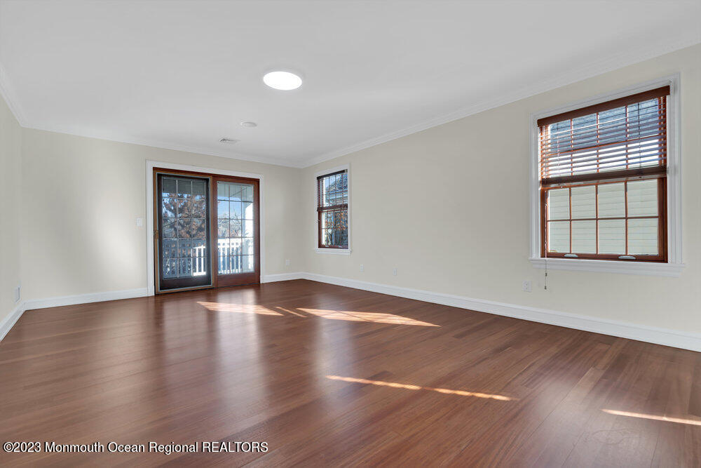 511 Passaic Avenue Spring Lake, NJ 07762 - Photo 94 of 105 an empty room with wooden floor and windows