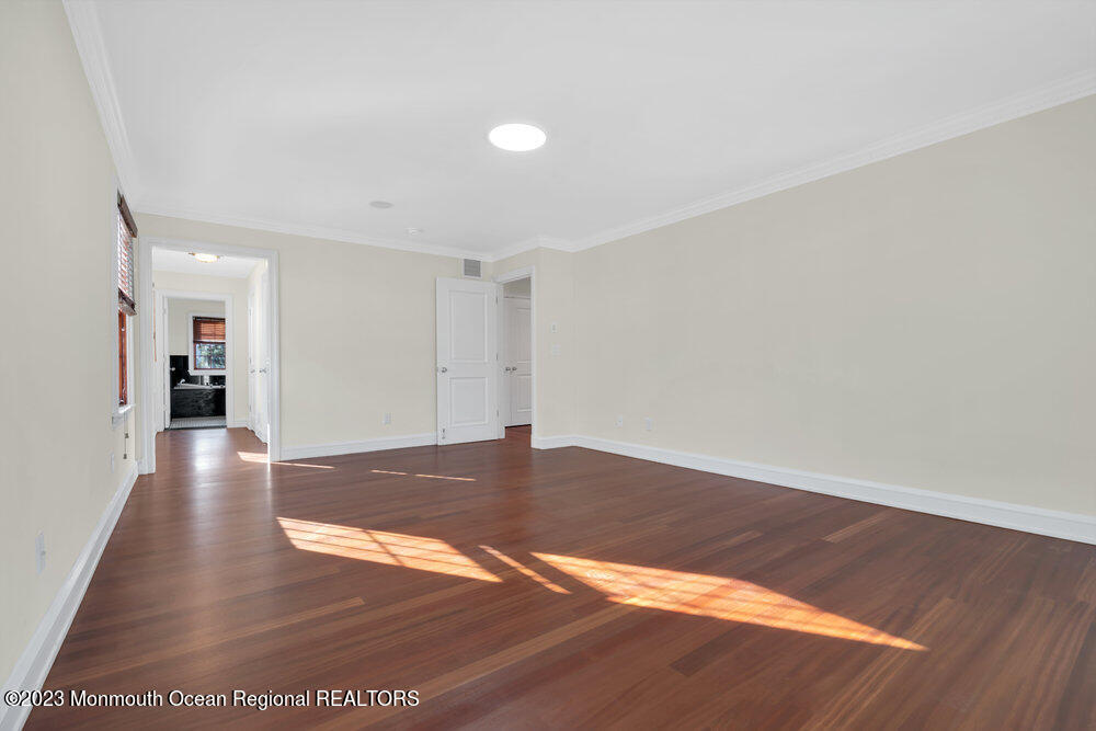 511 Passaic Avenue Spring Lake, NJ 07762 - Photo 95 of 105 a view of an empty room with wooden floor and a window