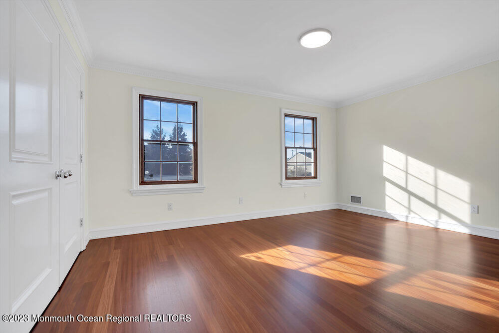 511 Passaic Avenue Spring Lake, NJ 07762 - Photo 98 of 105 an empty room with wooden floor and windows