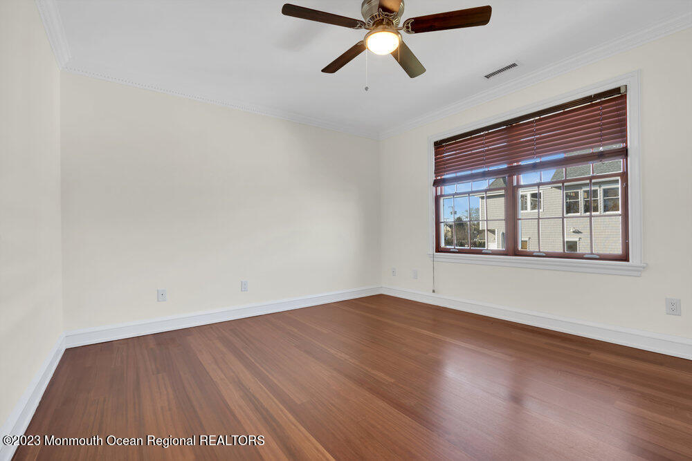 511 Passaic Avenue Spring Lake, NJ 07762 - Photo 99 of 105 an empty room with wooden floor and windows