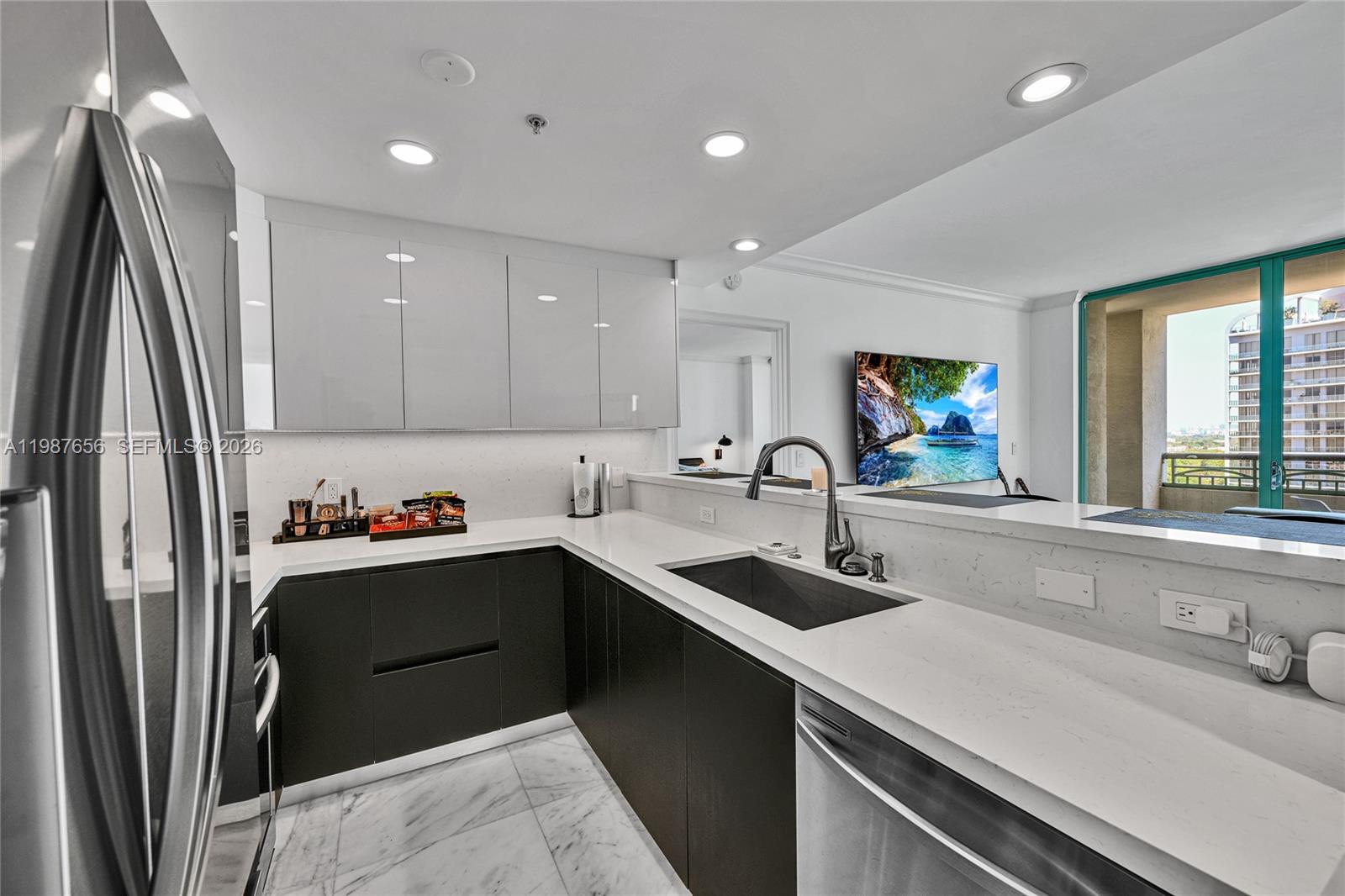 3350 Southwest 27th Avenue, Unit 1908 Coconut Grove, FL 33133 - Photo 14 of 17 a kitchen with stainless steel appliances a sink stove and refrigerator