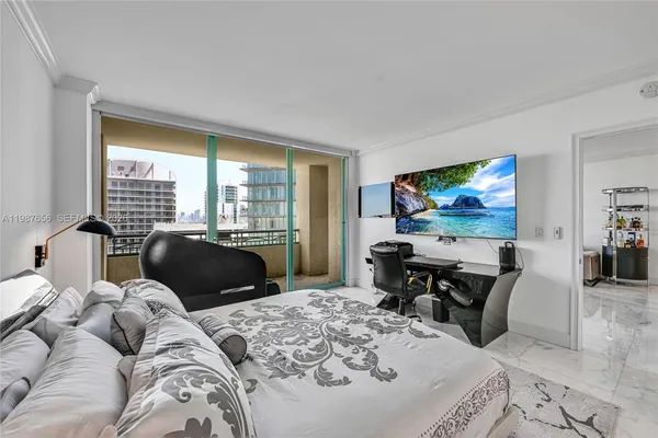 a bedroom with two beds and a flat screen tv