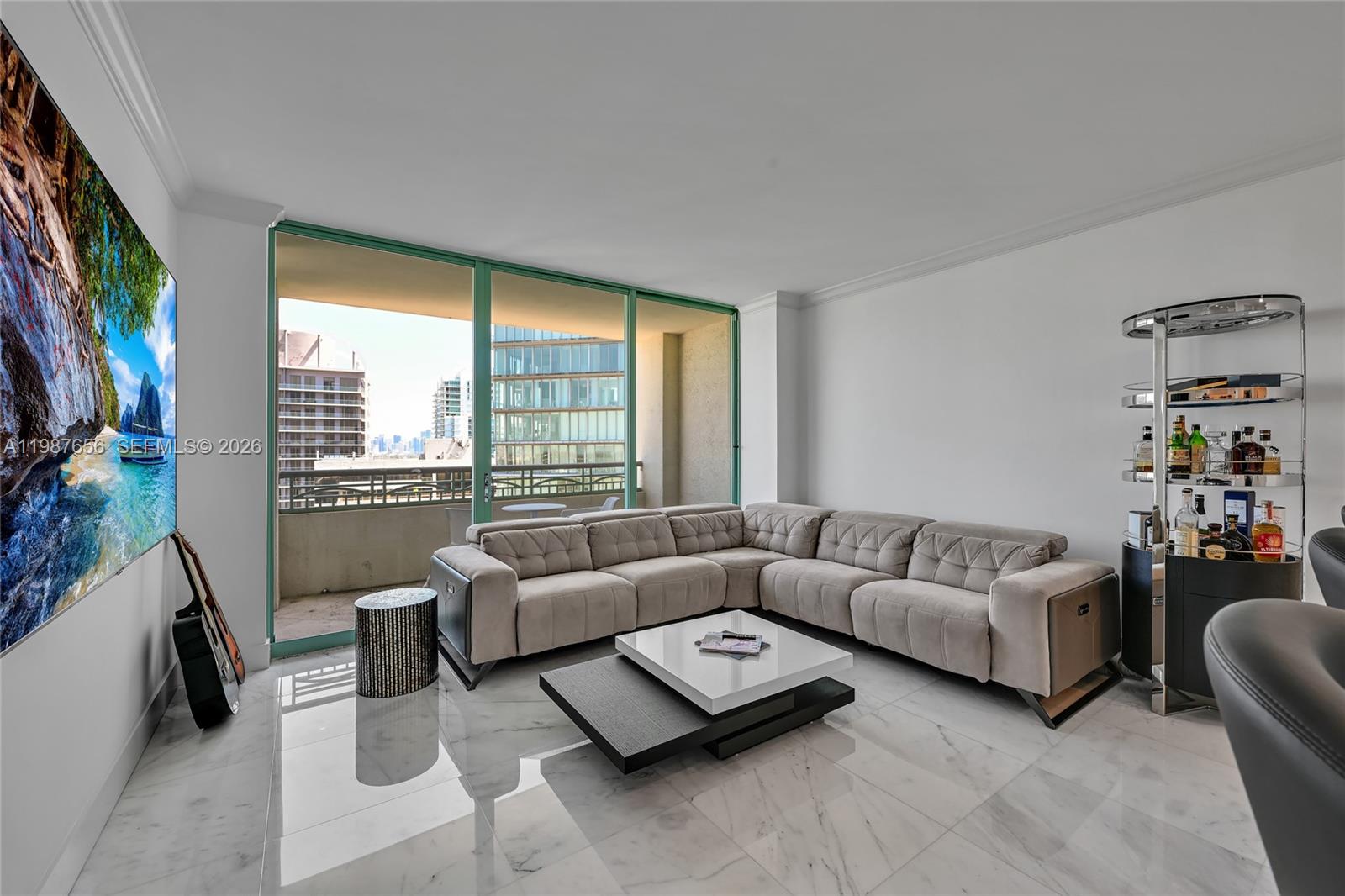 3350 Southwest 27th Avenue, Unit 1908 Coconut Grove, FL 33133 - Photo 6 of 17 a living room with furniture and a flat screen tv
