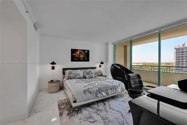 a bedroom with furniture and a large window