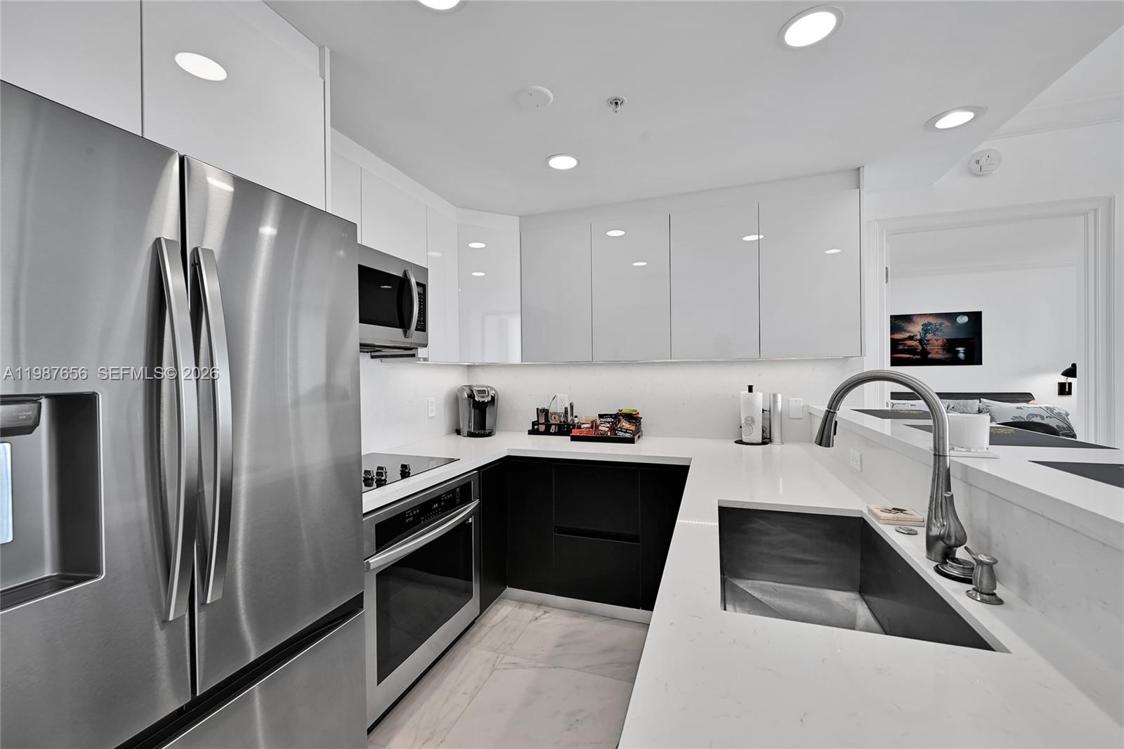 3350 Southwest 27th Avenue, Unit 1908 Coconut Grove, FL 33133 - Photo 9 of 17 a kitchen with a refrigerator sink and microwave