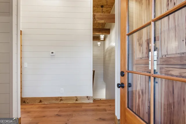a view of empty room with wooden floor
