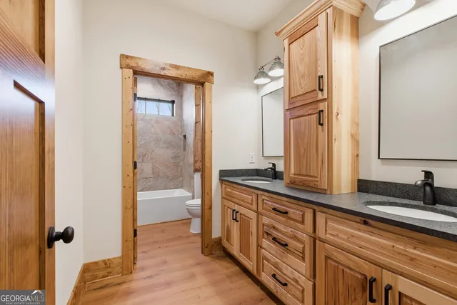 a view of a house with backyard and a trees