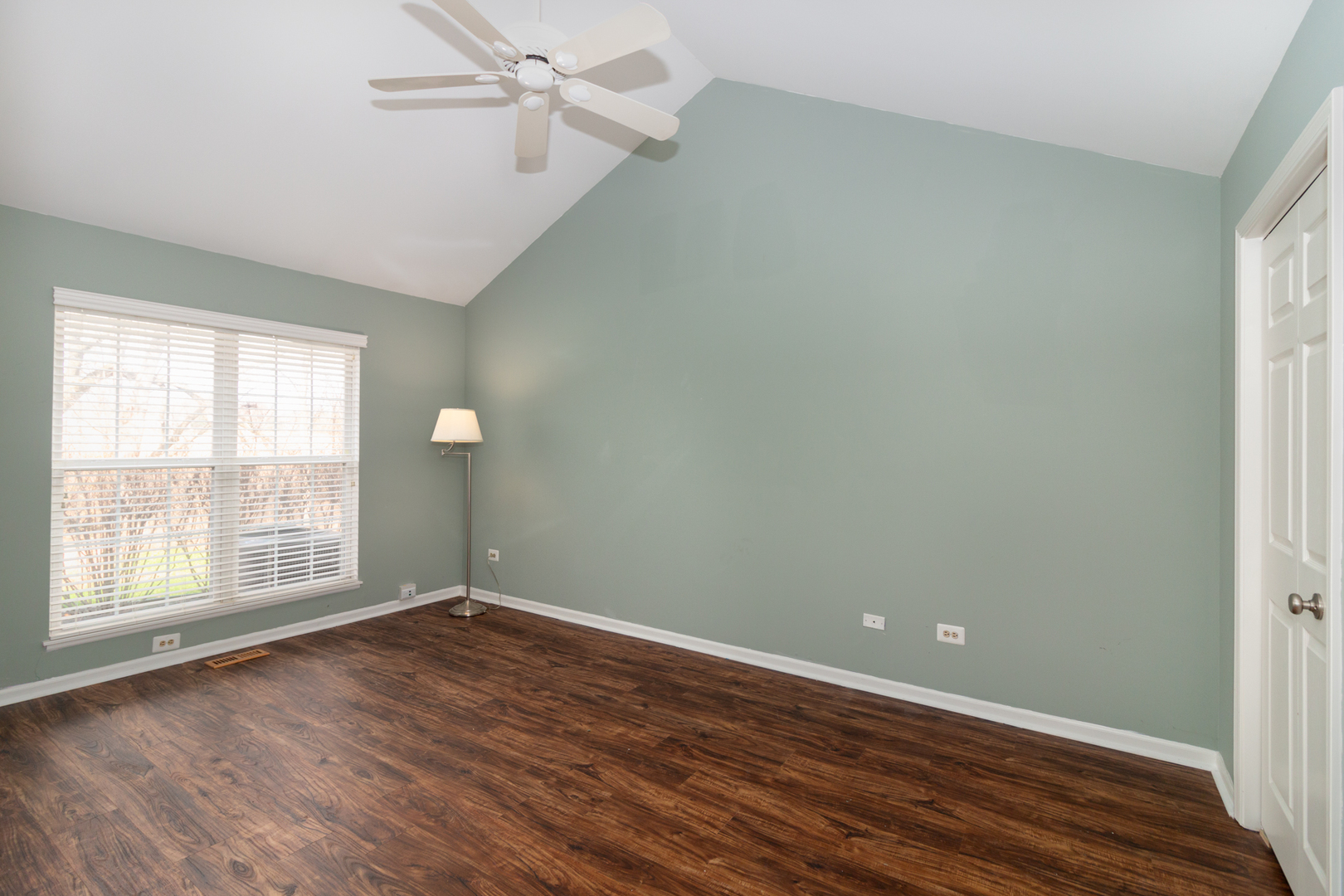 1176 Coldspring Road Elgin, IL 60120 - Photo 11 of 24 an empty room with wooden floor and windows
