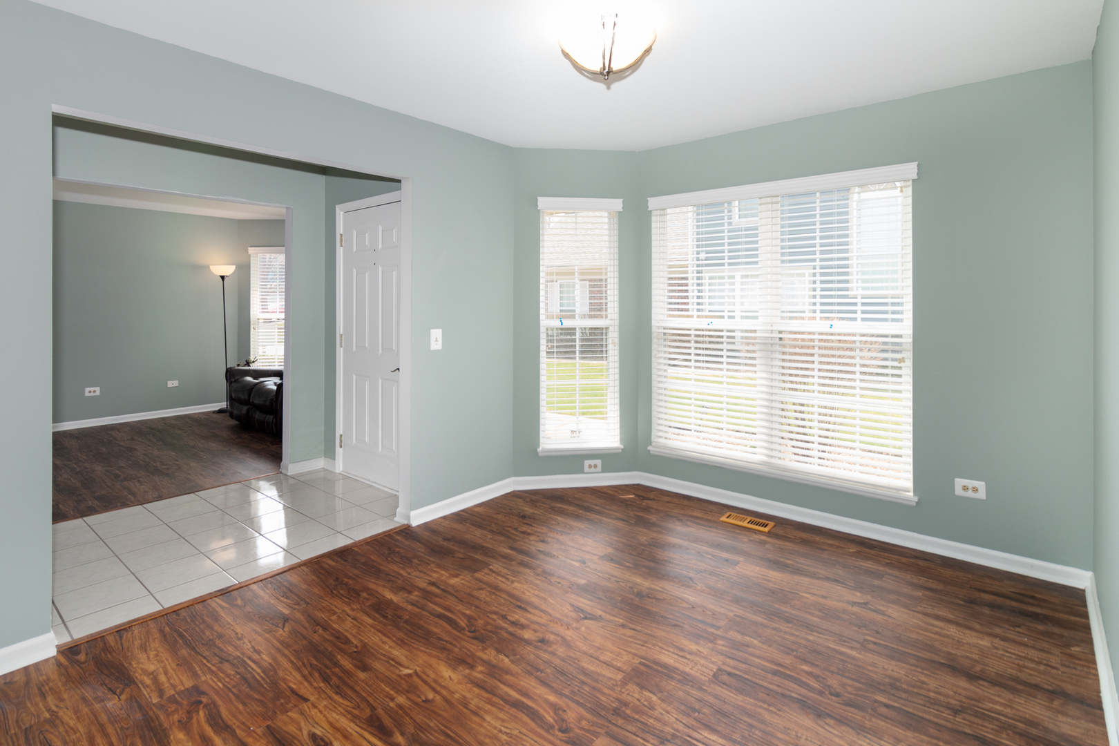 1176 Coldspring Road Elgin, IL 60120 - Photo 5 of 24 a view of a livingroom with wooden floor and a bathroom