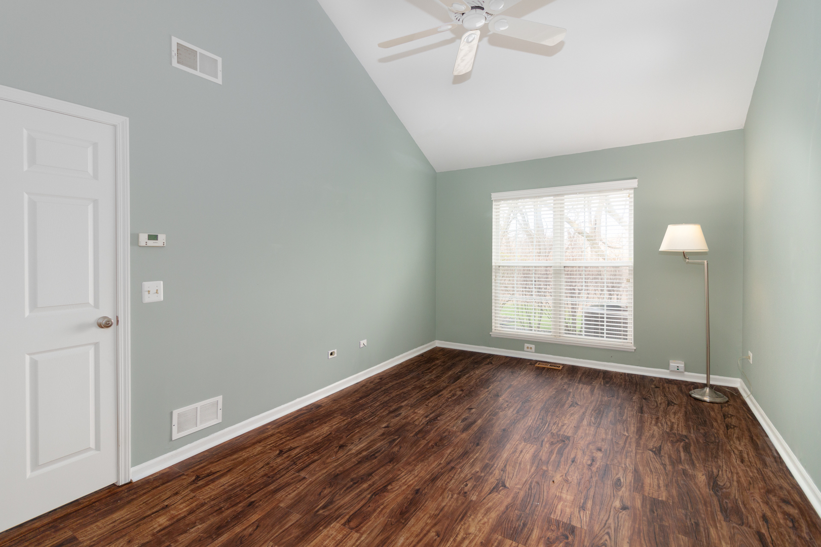 1176 Coldspring Road Elgin, IL 60120 - Photo 10 of 24 an empty room with wooden floor fan and windows