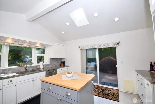 a kitchen with sink and refrigerator