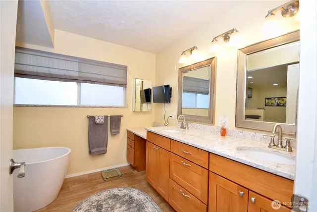 a bathroom with a toilet a sink and mirror