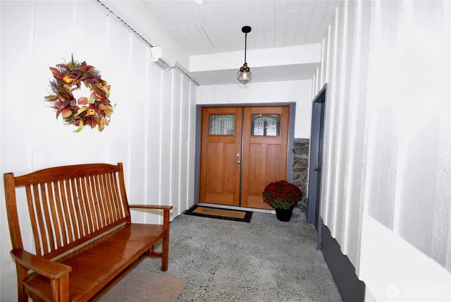 a view of hallway with furniture and a chandelier
