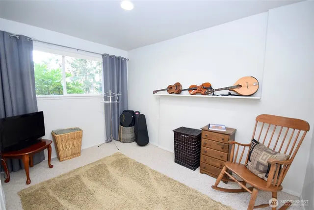a view of a house with a yard and sitting area