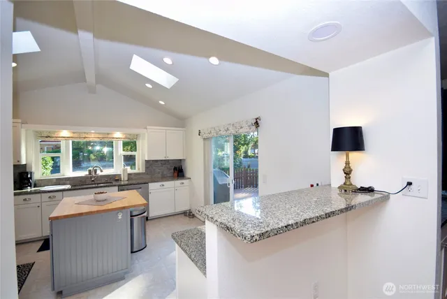a kitchen with sink stove and refrigerator