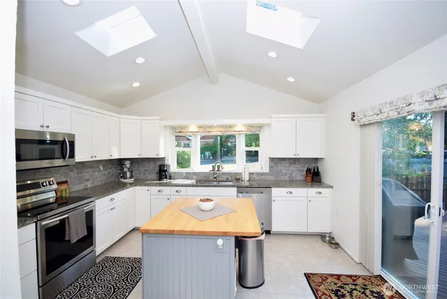 a kitchen with a sink a stove and cabinets