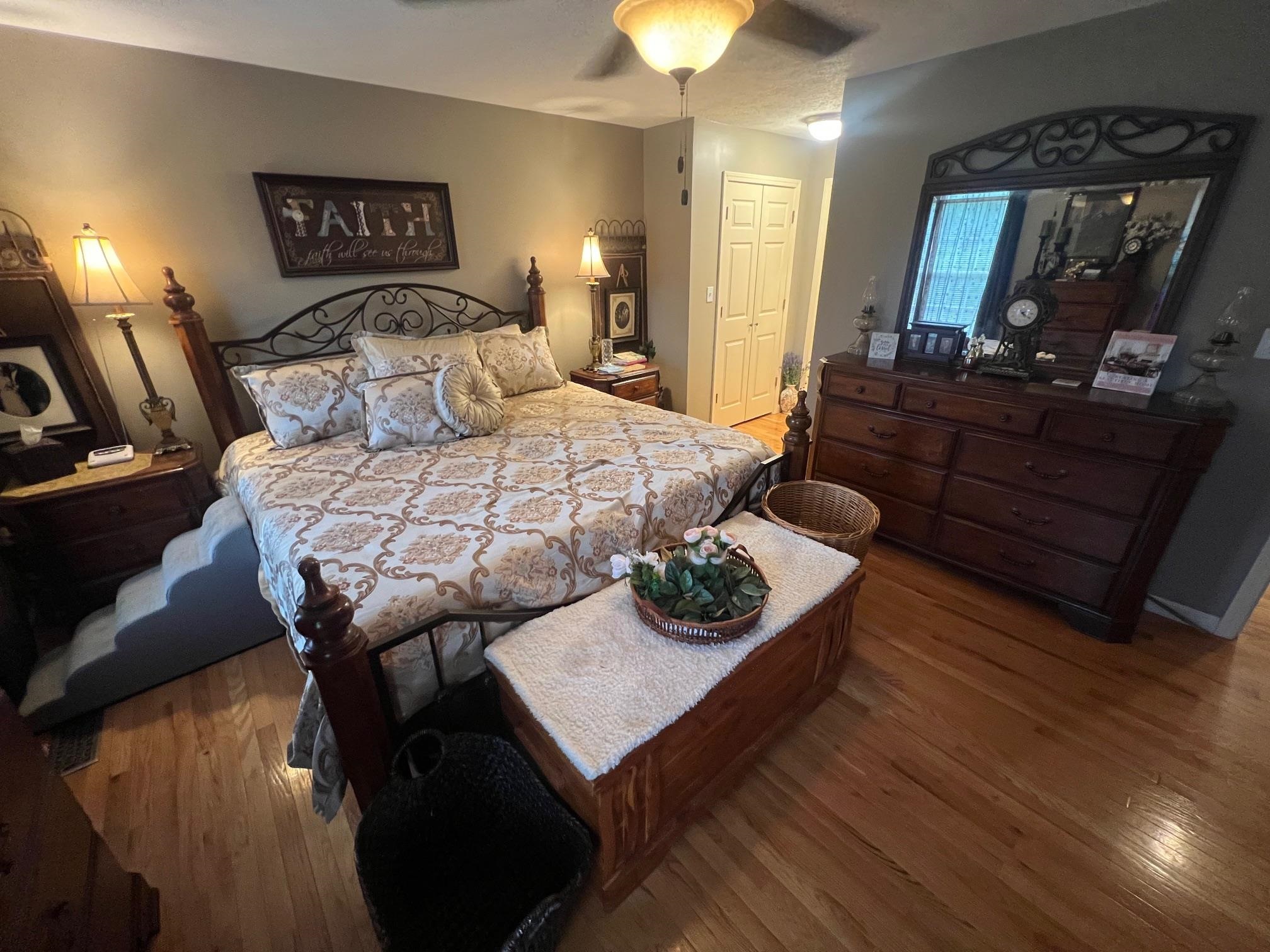 880 Double Springs Loop Savannah, TN 38372 - Photo 12 of 40 a bedroom with a bed and wooden floor